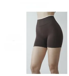 Detailed close-up of seamless dark brown high-waisted fitness shorts showing knit texture