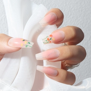 Pink and white gradient press-on nails with tulip floral patterns and silver glitter detail