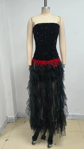 Detailed view of red feather waist trim and black sequins on mesh evening gown