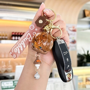 Creative bubble oil liquid keychain with brown floral ball and pink silicone wrist strap