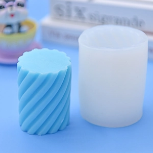 Detailed spiral twist texture on a cylindrical silicone mold with light blue finished candle