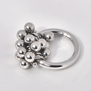 Detail of polished silver metal bead cluster on minimalist industrial stainless steel ring