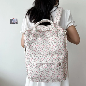 Floral canvas backpack with pink flower patterns and front pocket for school use