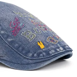 Washed denim flat cap for women with vintage embroidery and wide brim design