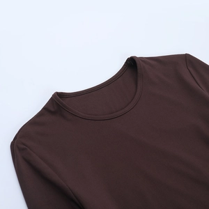 Detail view of round neckline and double stitching on dark brown long-sleeve knit top