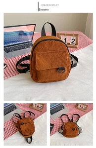 Detail of brown corduroy backpack with magnetic flap pocket and adjustable straps