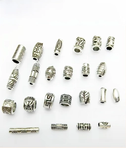 Detailed grid of 23 vintage silver alloy spacer beads with diverse embossed relief patterns