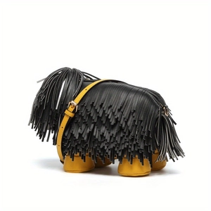 Detail shot of creative dog-shaped shoulder bag featuring black fringes and yellow leather strap