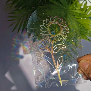 Rainbow prism effect on sunflower glass film with geometric texture in sunlight