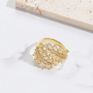 Detailed macro view of gold star moon ring with rectangular and round zirconia crystals