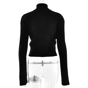 Detail of black ribbed knit turtleneck cropped top showing texture and slim fit design