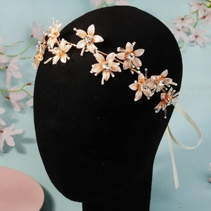 Detailed close-up of golden floral bridal headband with crystal petals and pearl accents