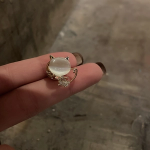 Macro shot of cute cat brooch featuring opal stone and sparkling diamond details