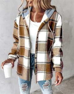 Detail shot of a casual plaid hooded jacket in brown and grey with cozy fabric texture