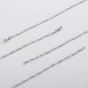 Detailed view of silver stainless steel bead chain with textured shuttle links and clasp
