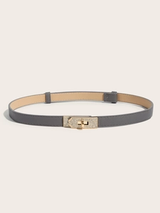Close-up of gray slim leather belt with a gold buckle encrusted with shimmering rhinestones
