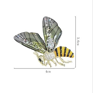 Detail view of the 4cm by 3.6cm bee brooch showing enamel body and crystal wings