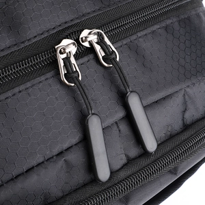 Macro view of water-resistant nylon fabric and durable dual zipper system on sport backpack