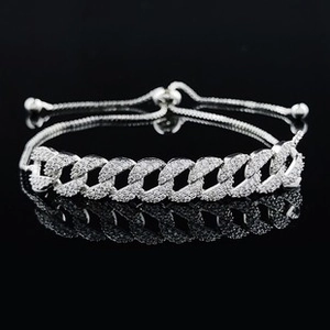 Detail of silver Cuban link bracelet with micro-paved zircons and adjustable drawstring closure