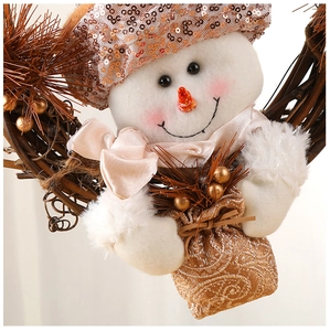 Close-up of a Christmas rattan wreath featuring a sequined snowman and pine needles