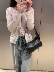 Mirror selfie showing the fit and style of a black vintage leather underarm shoulder bag