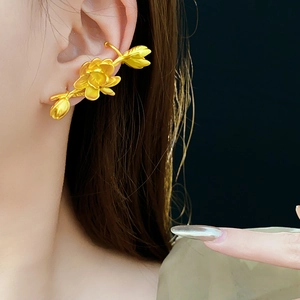 Side view of golden lotus flower earring on model showing elegant metallic details