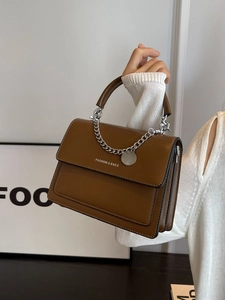 Brown leather crossbody bag with silver chain strap and stylish top handle for women