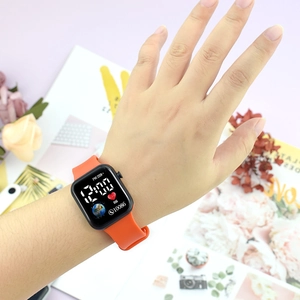 Detail of vibrant orange silicone strap and digital display showing health metrics