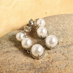 Elegant long stainless steel drop earrings with four gradient white pearls in silver setting