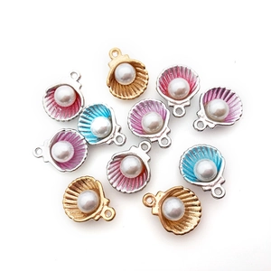 Detailed view of colorful shell jewelry pendants with pearls for DIY necklaces