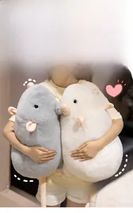Detailed view of large plush mouse dolls in grey and white with soft long fur texture