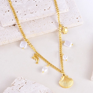 Ocean theme gold necklace with irregular pearls, dolphin, turtle and scallop pendants