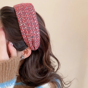 Detail of red and white tweed knit headband texture on female model with brown hair
