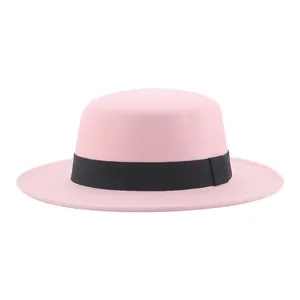 Detailed view of pink wool felt boater hat with a black ribbon band for children