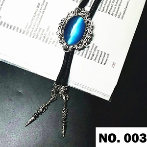 Detail of blue cat eye stone bolo tie with vintage silver frame and woven cord