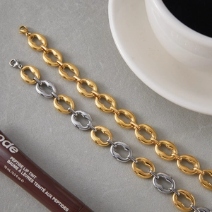 Close-up of two-tone stainless steel chain bracelet with secure lobster clasp detail