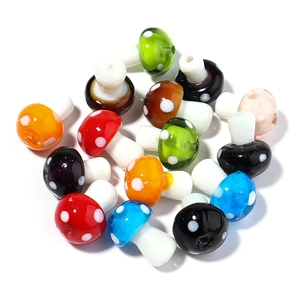 Close-up of colorful glass mushroom beads with polka dots for DIY jewelry making