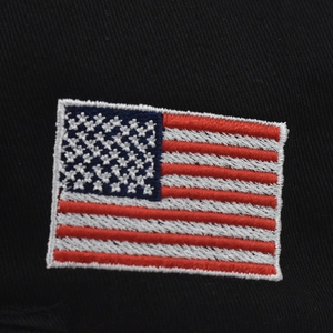 Macro detail of high-quality US flag embroidery patch on black cotton baseball cap