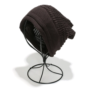Close-up of deep brown chunky knit slouchy beanie with textured diamond pattern