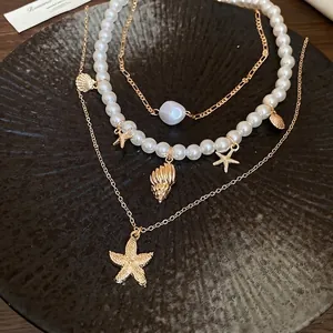 Vintage gold-plated layered necklace set with starfish, seashell pendants and white pearls