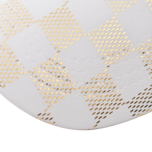 Detailed close-up of white twill baseball cap with golden diamond pattern and stitching