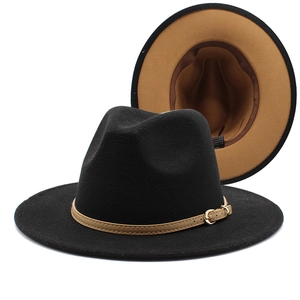 Detail view of two-tone wool fedora hat with black crown and camel brim lining