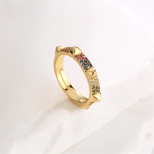 Macro shot of gold-plated ring featuring vibrant zircon stones and sharp gold spikes