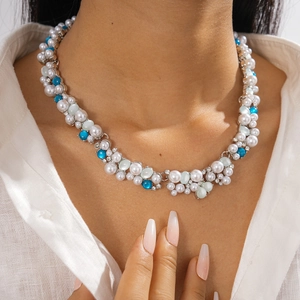 Detail shot of vintage rhinestone and pearl necklace with blue and green resin beads