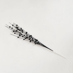 Detail shot of artificial black glitter berry stems with foam balls for Christmas decoration