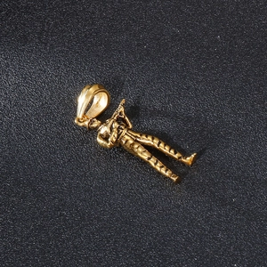 Macro shot of gold soldier pendant showing detailed uniform texture on black background