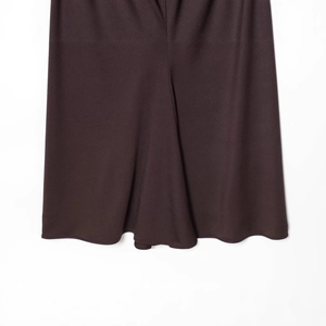 Deep brown halter neck dress hem with elegant drape and high-quality fabric texture