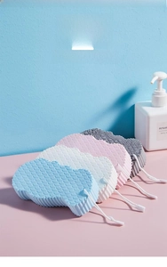 Detailed view of soft PVA bath sponges with wave texture and hanging ropes in four colors