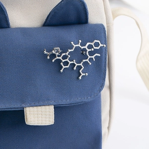 Blue and beige canvas bag with a silver chemical molecule formula enamel lapel pin
