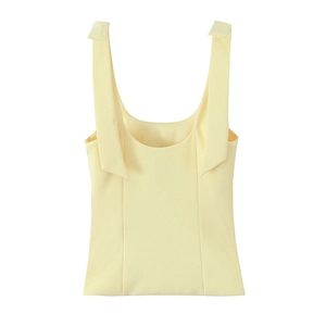 Flat lay of a light yellow sleeveless top with wide straps on a clean white background